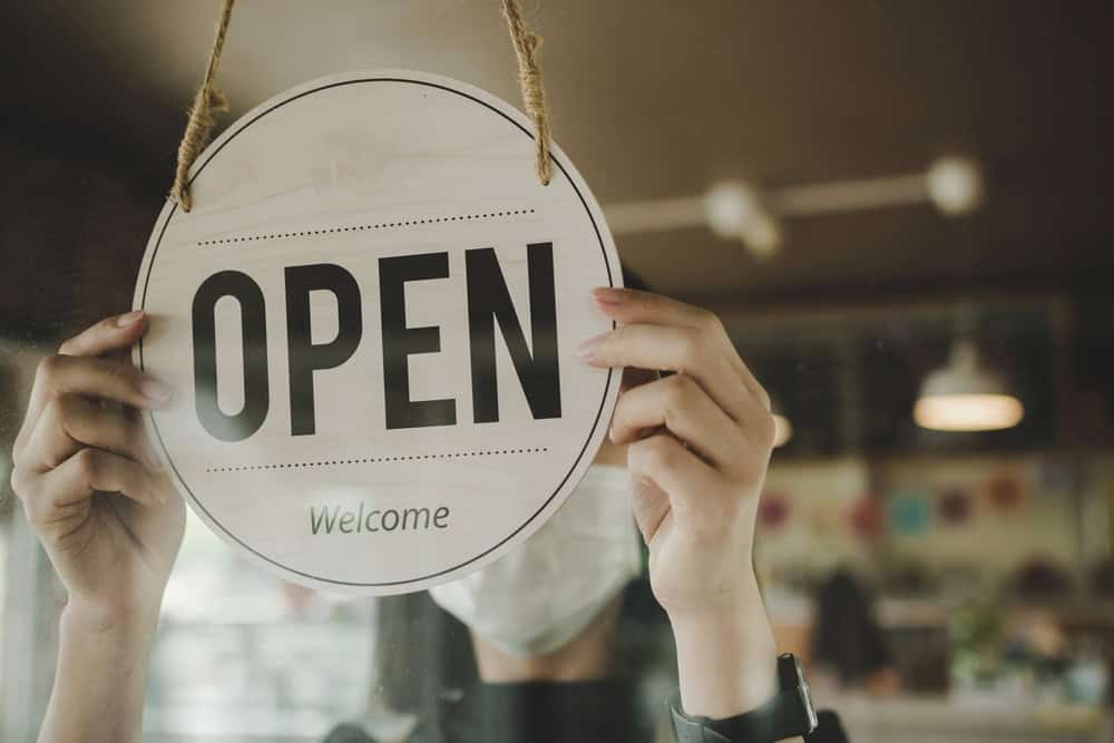 Open sign for small business or café, welcoming customers, storefront window, business opening, shop sign, retail, hospitality industry.