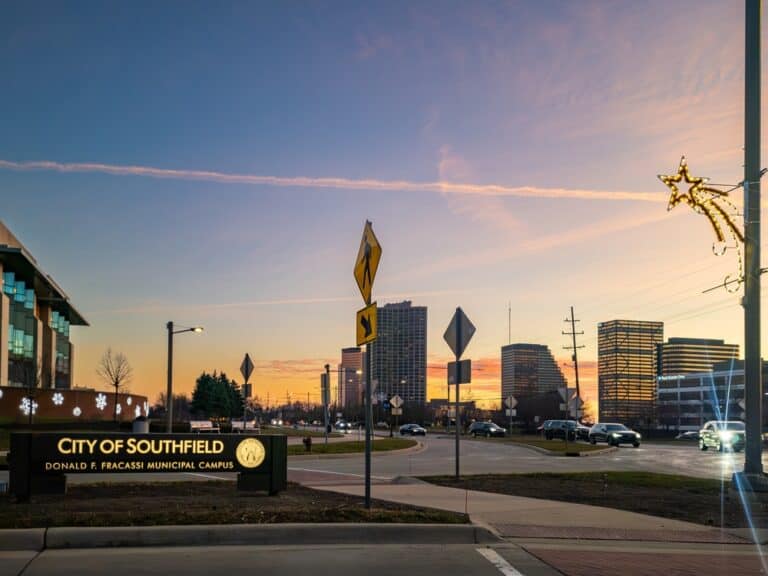 Modern cityscape at sunset featuring Southfield city sign and downtown buildings, highlighting urban development and vibrant community.