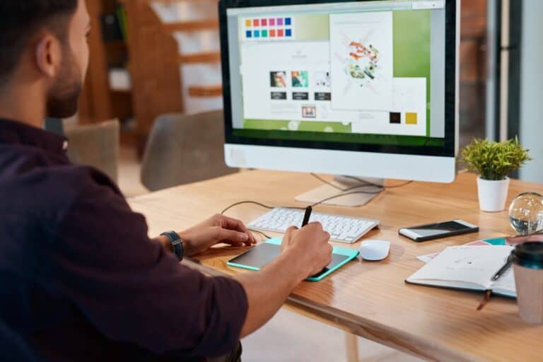Innovative graphic design work on a desktop computer with a drawing tablet, professional workspace environment.