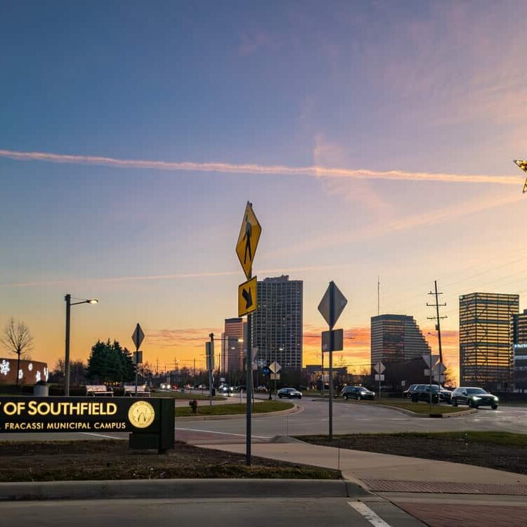 Modern cityscape at sunset featuring Southfield city sign and downtown buildings, highlighting urban development and vibrant community.