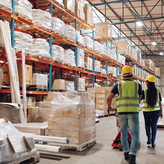 Warehouse staff inspecting inventory and products at Ignite Media Group distribution center.